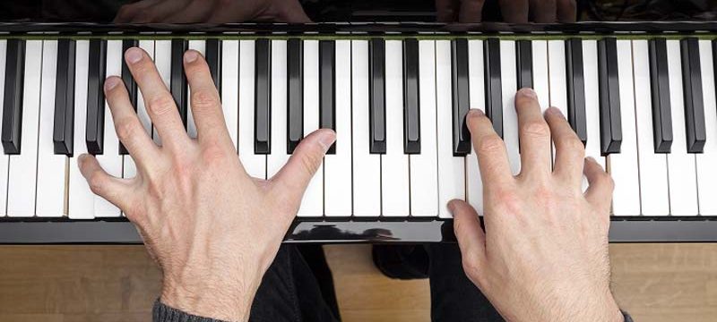 Hands on piano keys