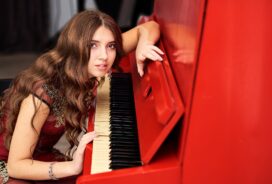 Woman playing red piano